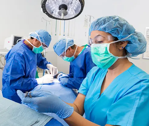 a women wearing scrubs working on a medical equipment.